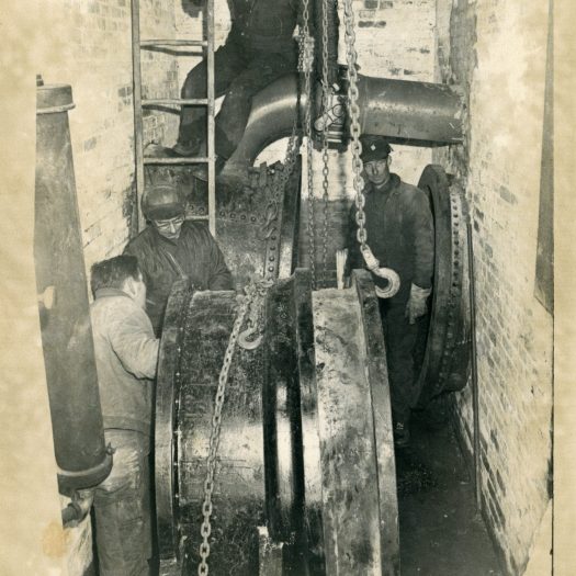 Photo of employees working on a 48-inch waste gate in the 1970s.